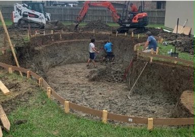 Crew shaping a pool excavation with a mini excavator and skid steer
